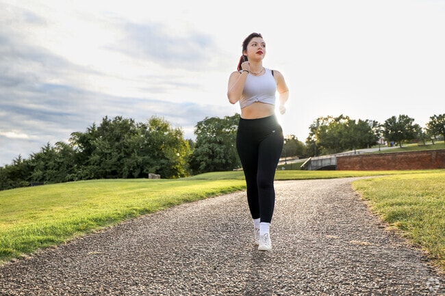 Athletic lady running in Rockwood Park at Golden Hour