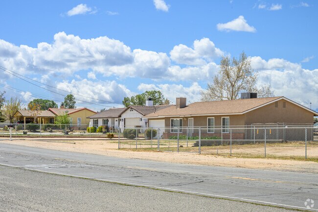 Fenced ranch homes in Golden Arrow Ranchos sit beside dirt-lined edges rather than sidewalks.