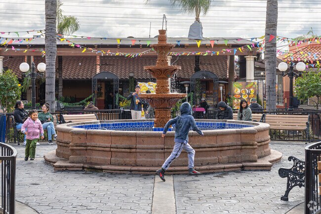 East Bakersfield children chase each other around the fountain at Plaza Del Pueblo.