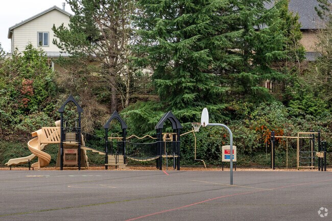 Basketball courts sit next to a large playground behind the school.