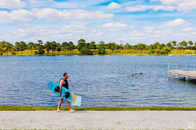 A resident heading to the pier for some wakeboarding fun in Palm Beach Ranchettes.