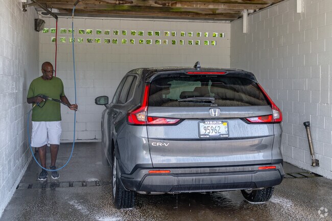 A local washes his SUV at a car wash located a short distance from Ravina Park.