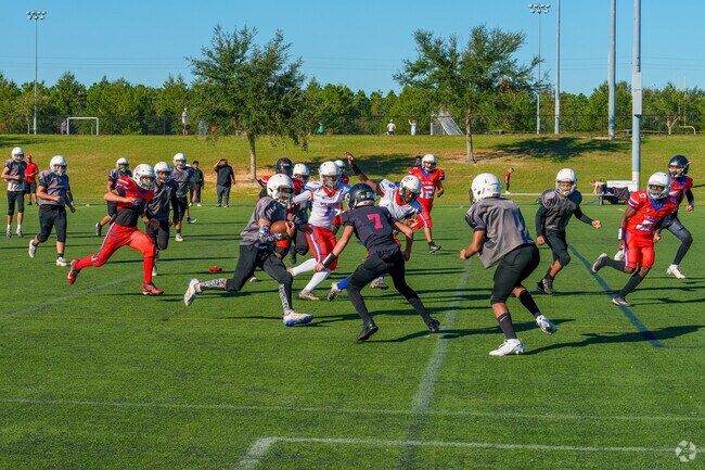 Davenport residents play football on the sprawling fields at Northeast Regional Park.