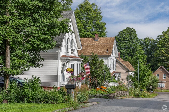 Homes in Meredith often have beautiful greenery and blooming flowers.