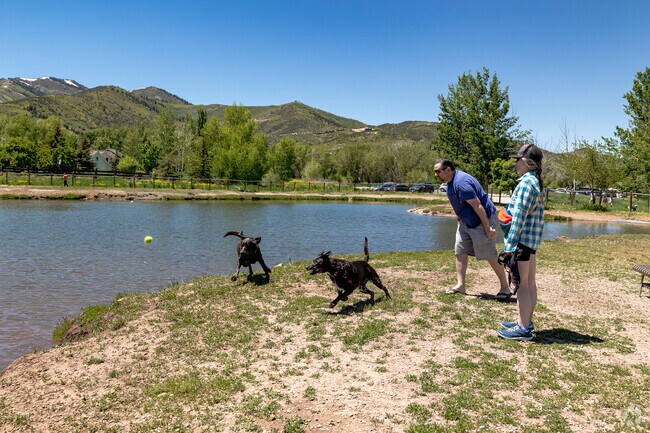 A couple enjoys the dog park at Willow Creek Park.