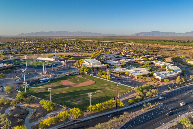 Sahuartia High School spans a large campus in Rancho Sanhuarita, featuring athletic fields, modern buildings, and nearby neighborhoods.