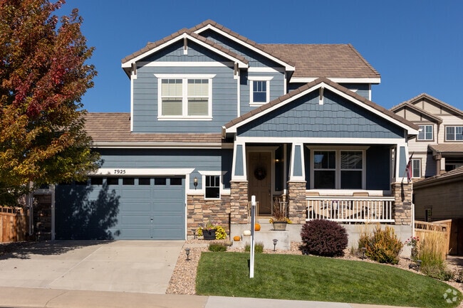 This split-level home in Cobblestone Ranch features a small yard and a covered porch.