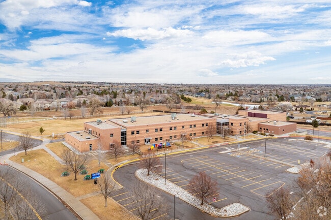 The large parking area and school building at Coyote Ridge Elementary School in Broomfield, CO.