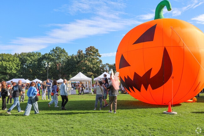 Residents can take a picture in front of the giant jack-o-lantern at the Haunted Happenings Marketplace in the fall in Downtown Salem.