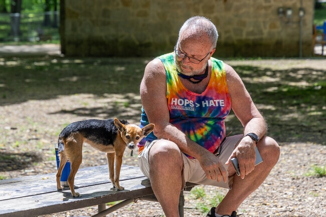 This area resident enjoys a sunny day with his dog at Triangle Park, close to Santa Clara.