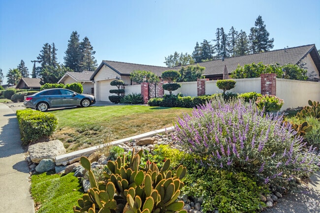 Colorful flowers bloom in front of a home in Brookside.