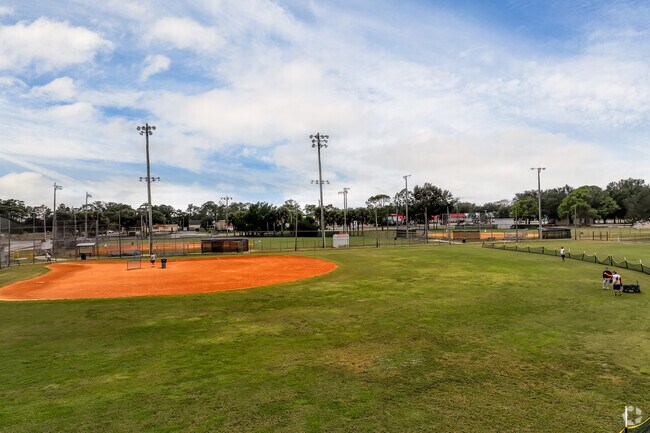 Batting practice at Fay Parks softball league on a windy afternoon.