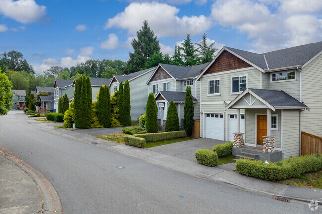 Contemporary craftsman homes occupy large lots on NE 199th St in Westhill.