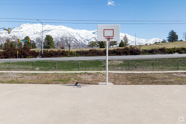 Locals shoot hoops at the Lion’s Park basketball court in Washington Terrace.