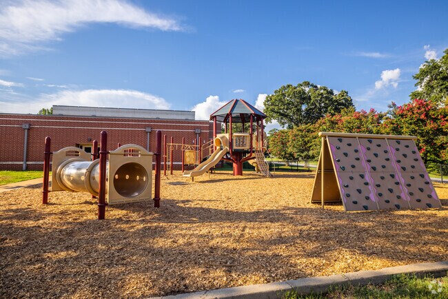 Students at Sara Collins School in Verdae enjoy playing at recess on the rock wall.