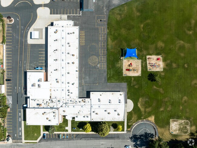 An aerial view of Grant Elementary School shows the building next to various play areas.