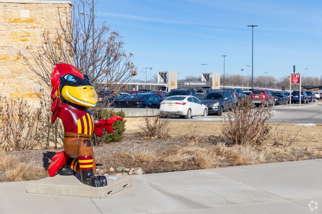 Iowa State mascot Cy welcomes Northeast Ames residents to Jack Trice Stadium on gameday.