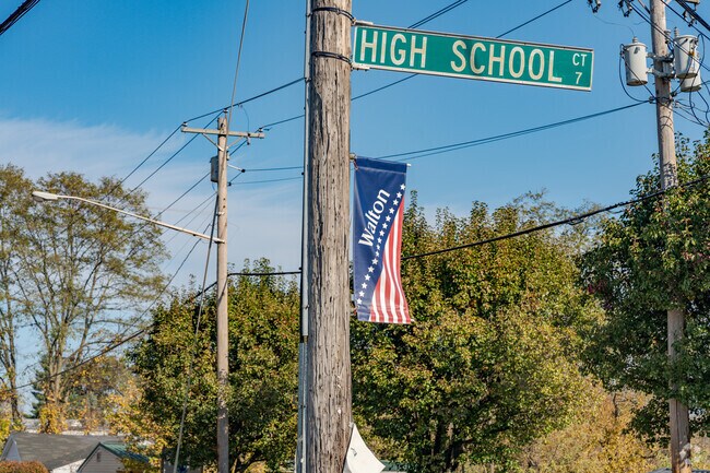 Light posts in Walton welcome visitors with signs.