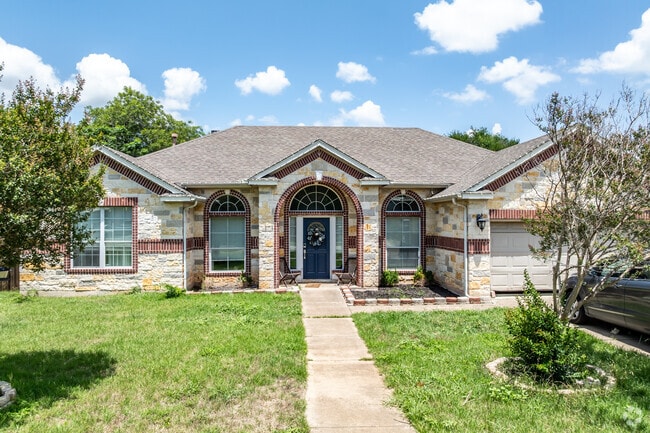 This Mediterranean Revival has terra-cotta inlay with rock construction in Cedar Park Ranchettes.