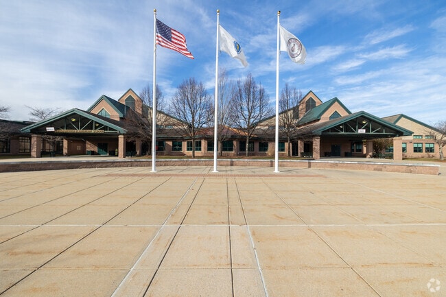 The American flag waves proudly in front of the Tyngsboro Elementary School entrance.