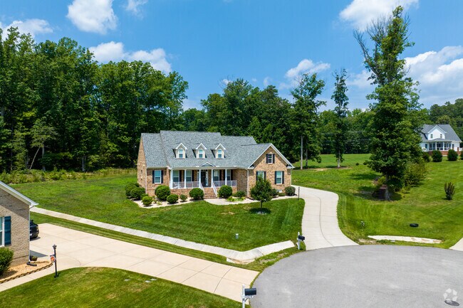 Brick Cape Cods style homes sit on lots  with maintained lots.