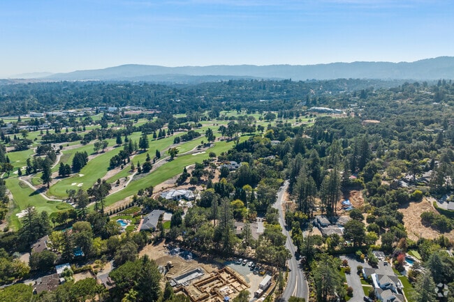 Woodside Hills offers a serene, lush setting with expansive views of nearby golf courses.