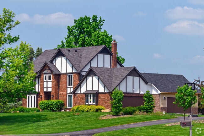A large, Tudor Revival home sits on a large lot in Travis Pointe.