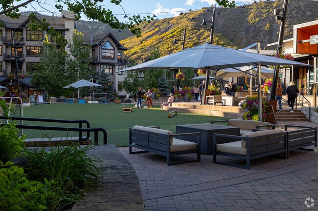 Outdoor seating at Base Village offers mountain views and a lively social scene.