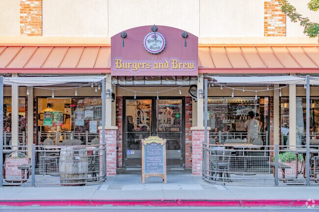 Friends gather safely from the heat at Burgers and Brew near East Streets.