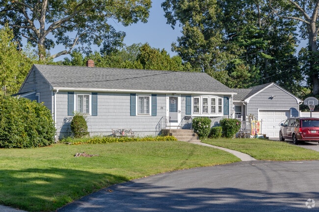 This ranch home in Hillsgrove showcases exceptional landscaping and a cozy garage.