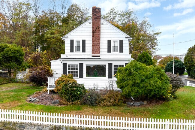 New England-style homes with white picket fences line the streets of Natick, Rhode Island.