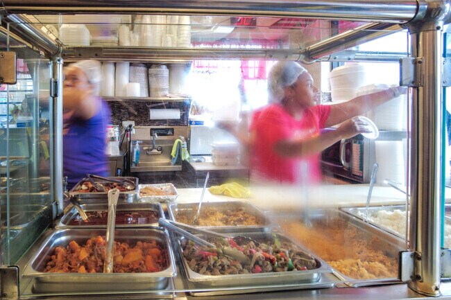 The employees at El Principe Restaurant in the McGuire neighborhood preparing the orders.