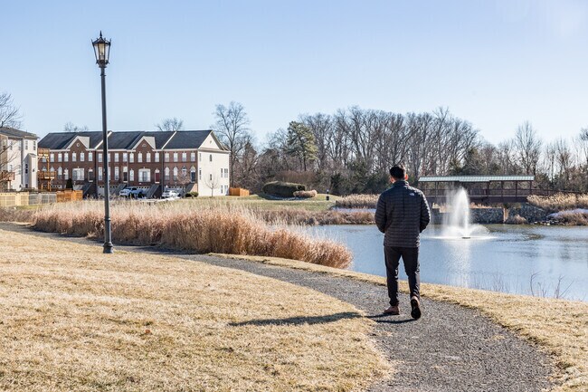 Explore the scenic trail at Kirkpatrick Farms with a serene pond as your backdrop.