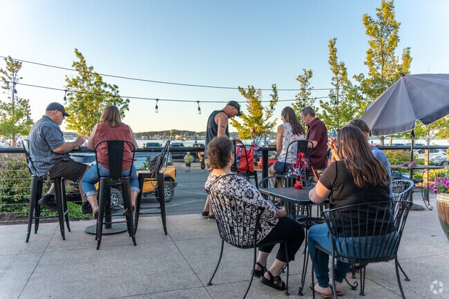 Experience waterfront dining at its finest with Peninsula BevCo's outdoor bay view seating.