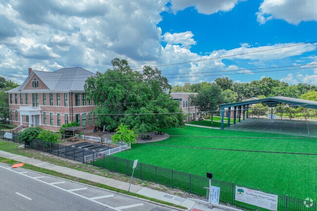 Academy Prep Center of Tampa has outdoor play areas next to the main building.