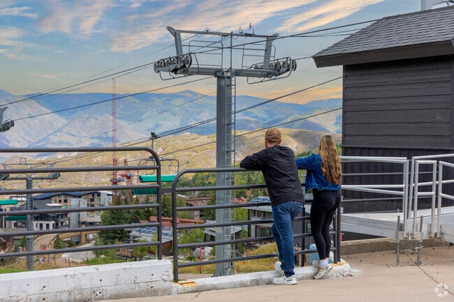 Gondolas at Snowmass carry visitors to slopes and scenic mountain views.