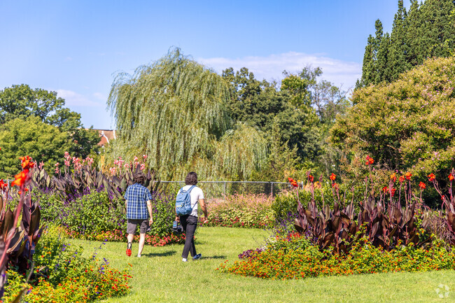 Just outside of Mondawmin, two people enjoy a summer day in the Rawlings Conservatory.