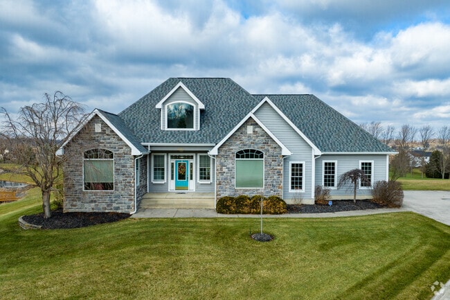 Two-story, four-bedroom Craftsman homes with stone and siding are common throughout Bloom.