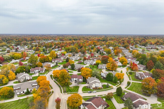 Trees wear fall colors and manicured lawns welcome visitors to Sawmill Woods.