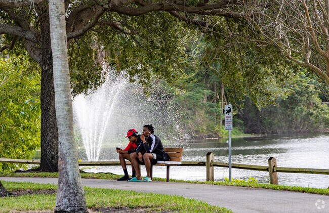 Kids sit on a park bench in the Northshore neighborhood of West Palm Beach.