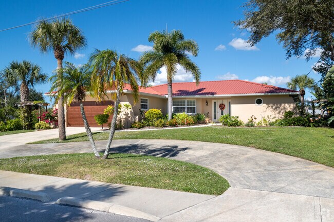 Florida Ranch style homes with red tile roofs and tropical landscaping are prominent in the area