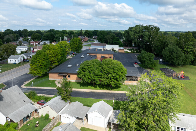 Mark Twain School is surrounded by dense trees.
