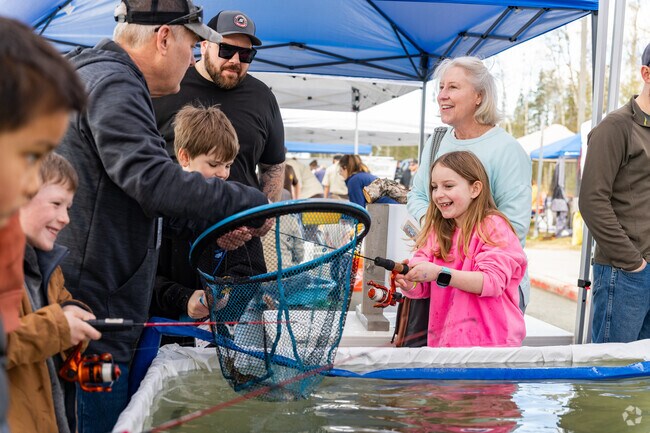 Children catch trout during the Kenai Sports Show, which brings together the whole family.
