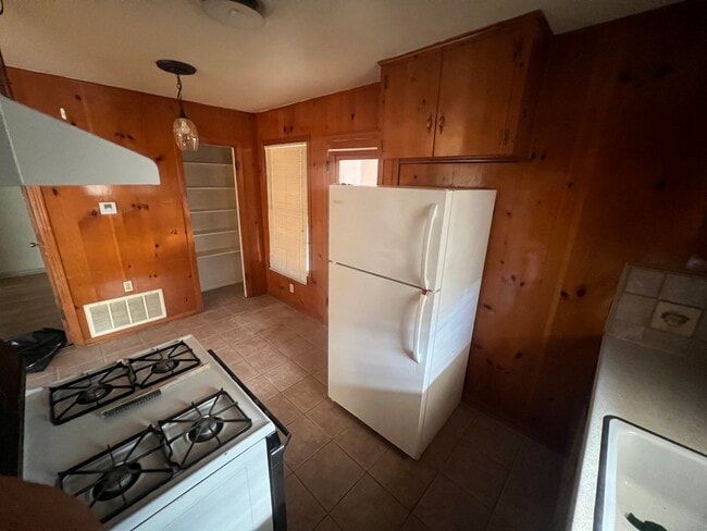 Kitchen with gas range, refridgerator, pantry and lots of cabinets