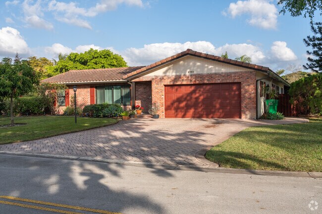 Single-family homes in Forest Hills feature large driveways and front yards.