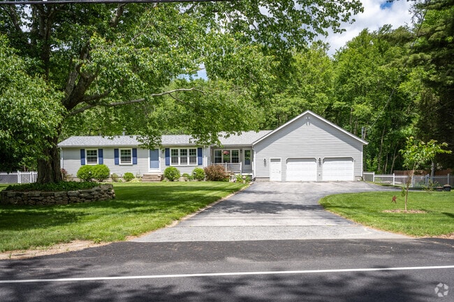 Shippeetown, RI, where lush greenery frames ranch homes, radiating charm and natural beauty.