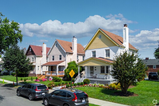 Two-story homes with gabled roofs and covered porches on Rand Pl NE.