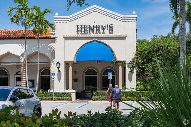 Visitors walk toward Henry’s restaurant near Addison Reserve.