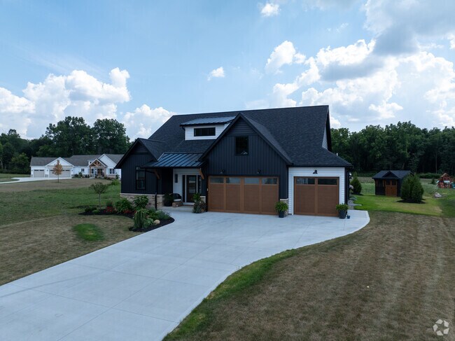 Explore upscale living in this custom-built Modern Farmhouse on a spacious lot.