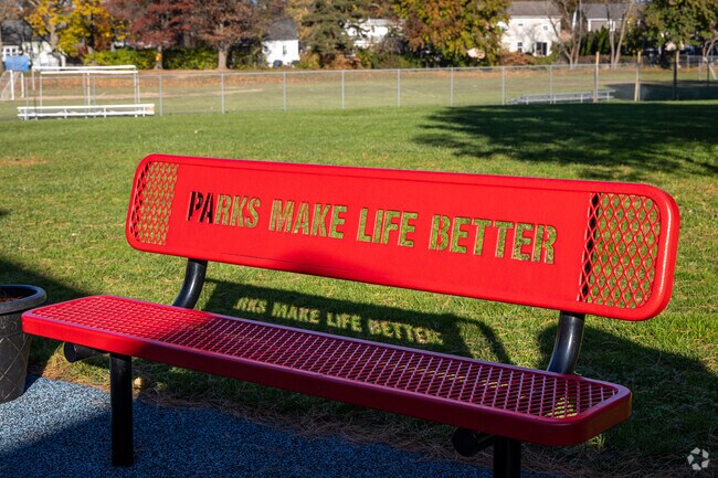 Milton Campbell Field in Plainfield, NJ, has unique benches stating 'Parks Make Life Better'.